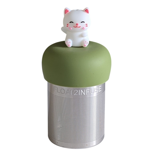 Happy white cat tea infuser with a green base for loose leaf tea with a fine mesh stainless steel tea strainer that reads FLOAT2INFUSE with a white background
