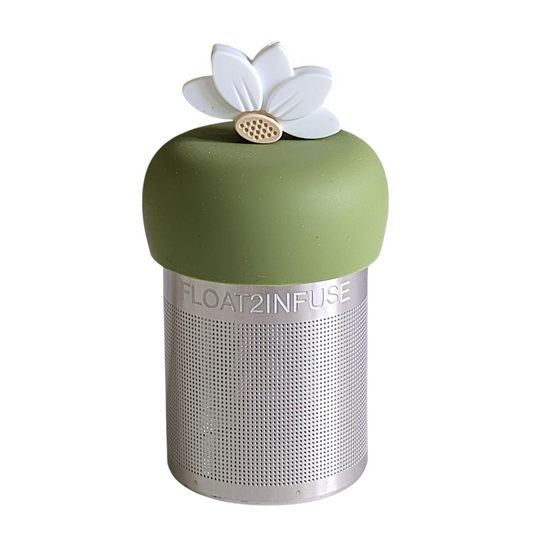 white lotus flower tea infuser for loose leaf tea with a fine mesh stainless steel tea strainer that reads FLOAT2INFUSE on a green base with a white background